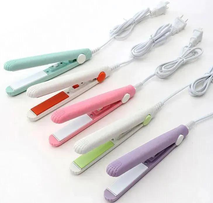 Set of colorful mini hair straighteners on a white background